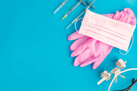 Medical equipments including surgical instruments on a blue background. top view, copy spaseの写真素材