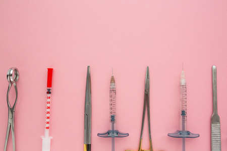 Flat lay of medical instruments on rose background. Mock up health care medical background.の写真素材