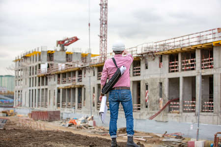 Senior architect or engineer thinking and looking up expressing doubt and wonderの写真素材