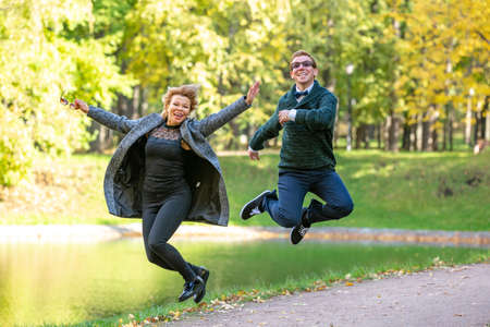 Young couple having fun in the autumn forestの写真素材