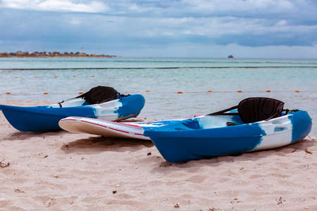 Active rest, sport, kayak. Boat for rafting on water. A few kayaks stand on a sandy beach.の写真素材