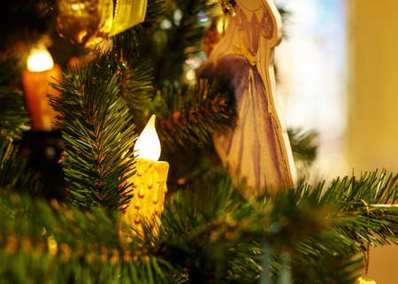 Christmas tree with golden toys. Concept New Year celebration background. Closeup photo of christmas tree decorated with golden toysの写真素材