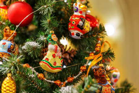 Christmas tree with colorful toys. Concept New Year celebration background. Closeup photo of christmas tree decorated with colorful toysの写真素材