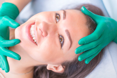 Cosmetic surgeon examining female client in clinik  before plastの写真素材