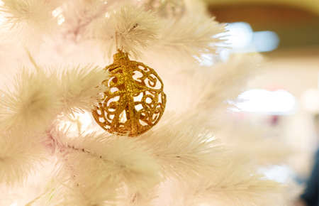 Christmas tree with golden balls. Concept New Year celebration background. Closeup photo of white christmas tree decorated with golden ballsの写真素材