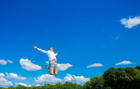 Guy is hovering in the air. The guy is hovering in the air against the background of a fountainの写真素材