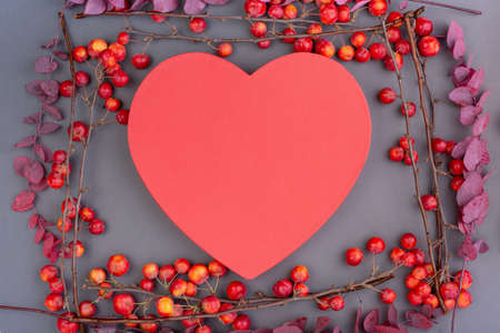 Blossoming apple tree branches with decorative red heart on gray background. Copy space. Valentines day, the holiday of loveの写真素材