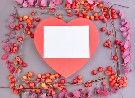 Blossoming apple tree branches with decorative red heart on gray background. Copy space. Valentines...