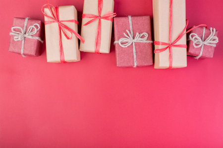 Christmas composition. Christmas red decorations, stars and gift boxes on red background. Flat lay,...