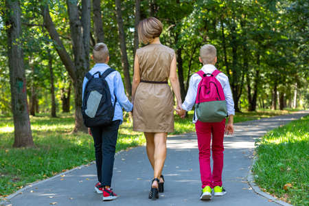 Happy young family, mother with two boys walking in the park. Healthy lifestyle conceptの写真素材