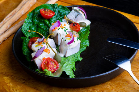 delicious Restaurant Dish Vitello Tonato in restaurant background. Healthy exclusive food on big...