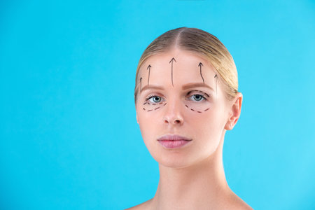 Beautiful Woman Face. Beauty Portrait of young woman blond, painted lines on the face for cosmetic...