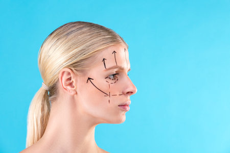 Beautiful Woman Face. Beauty Portrait of young woman blond, painted lines on the face for cosmetic...
