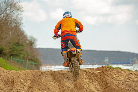 Professional Motocross Motorcycle Rider Drives Over the Road Track.