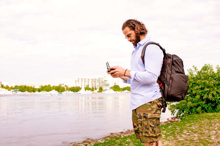 The console from the drone is in the hands of a young man. A handsome man controls a quadrocopter.の写真素材