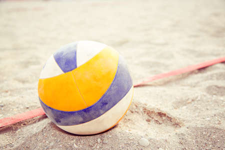 Beach Volleyball. Game ball under sunlight and blue sky. Volleyball in the sand at the beachの写真素材