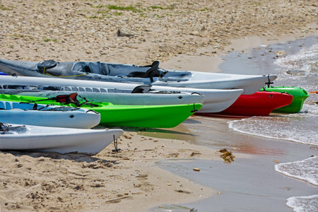 Colourful kayaks on sandy beach. The concept of active rest