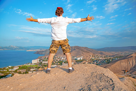A man overlooking a panoramic view of a beautiful coastline