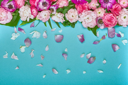 Beautiful floral background, texture, wallpaper. Flat-lay of pink flowers on blue background, top...