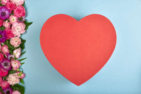 beautiful card for the holiday of love. Background for Valentines Day. Postcard. Pink flowers on a blue background and red hearts for textの写真素材
