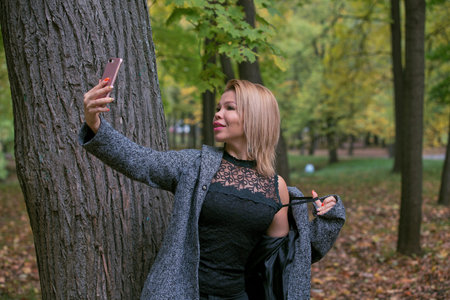 Young woman taking a selfie at the park