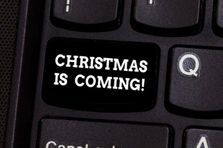 Text sign showing Christmas Is Coming. Conceptual photo annual Christian festival celebrating Christs birth here Keyboard key Intention to create computer message pressing keypad ideaの写真素材
