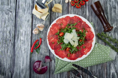 close-up carpaccio meat with arugula and slices of parmesan cheeseの写真素材