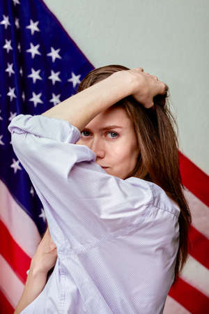Beautiful girl in shirt on american flag background. Patriotic conceptの写真素材