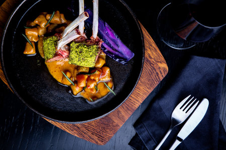 Close up of lamb chops with vegetables with a sauce of caramel, pepper and spices in a restaurant...