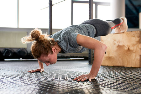 Athletic attractive woman wrung out in gym. Training concept, sport, workout process