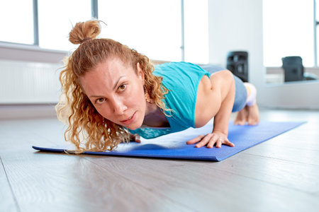 Athletic attractive woman wrung out in gym. Training concept, sport, workout process