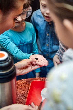 Chemical show for kids. Professor carried out chemical experiments with liquid nitrogen on Birthday little girl.