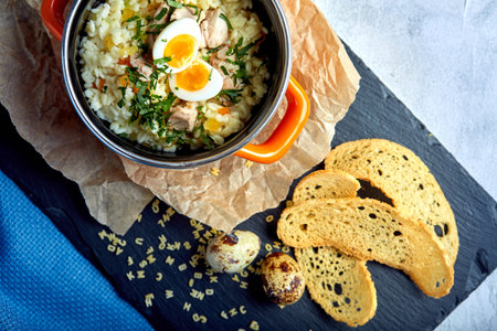 Cook noodles soup with egg in a small saucepan. Helthy meal.