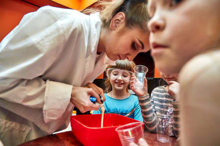 Chemical show for kids. Professor carried out chemical experiments with liquid nitrogen on Birthday little girl.の写真素材