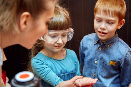 Chemical show for kids. Professor carried out chemical experiments with liquid nitrogen on Birthday little girl.の写真素材