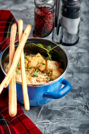 Beef stroganoff with mashed potatoes in a pot. top view, stone background