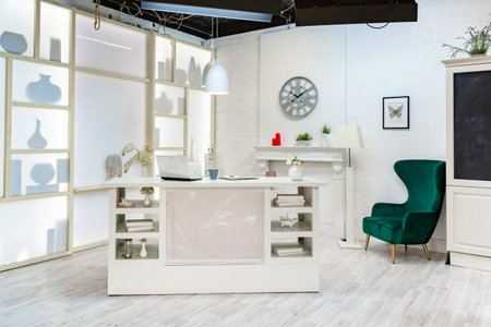modern white studio. with a light stand in the middle, with a special light on the back wall.