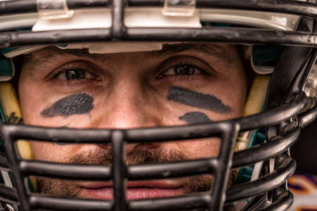 Portrait close-up, American football player, bearded in helmet. Concept American football, patriotism, close-up.の写真素材
