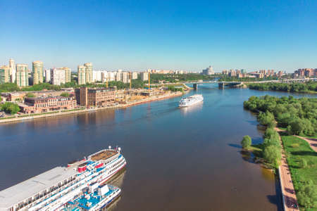Scenic view of the city by the river with ships sailing on it. Concept clean city, life in the city. aerial shot, top shotの写真素材