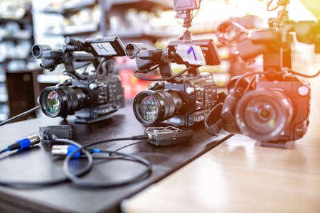 Behind the scenes of video production or video shooting. The concept of production of video content for TV, blog, shows, movies. Cameras prepared for video filmingの写真素材