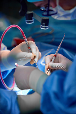 Close up portrait of female surgeon doctor wearing protective mask and hat during the operation....