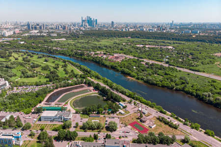 Aerial view of the city from intersections and roads, houses, buildings, parks and parking lots, bridges. Shooting from the air. Panoramic image.の写真素材