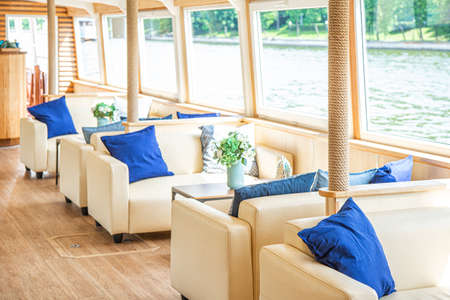 The interior of the urban river ship, with a panoramic view of the urban landscape. The concept of tourism, recreation, walking around the city, rest in the city. River transport.の写真素材