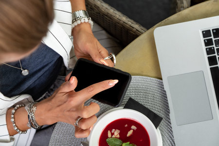 Businesswoman working during the lunch with salad sitting at the vegan restaurant on the beautiful...