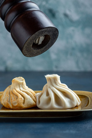 Khinkali, Georgian dumplings, traditional Georgian cuisine. Khinkali on a plate side view.