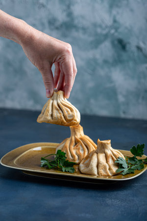 Khinkali, Georgian dumplings, traditional Georgian cuisine. Khinkali on a plate side view.