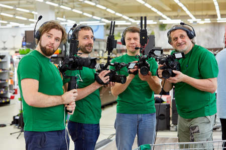 Behind the scenes of movie shooting or video production and film crew team with camera equipment at outdoor location.の写真素材