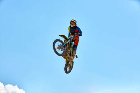 Biker does the trick and jumps in the air. Extreme concept, adrenaline. Copy space. Sky backgroundの写真素材