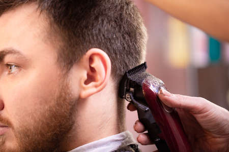 Close up of a male student having a haircut with hair clippersの写真素材