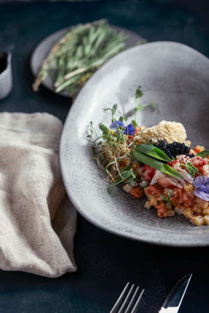 Olivier with crab meat in a beautiful bowl in the form of oysters, on a dark background. Food photo in no way, the concept of food fashion. Healthy nutrition.の写真素材